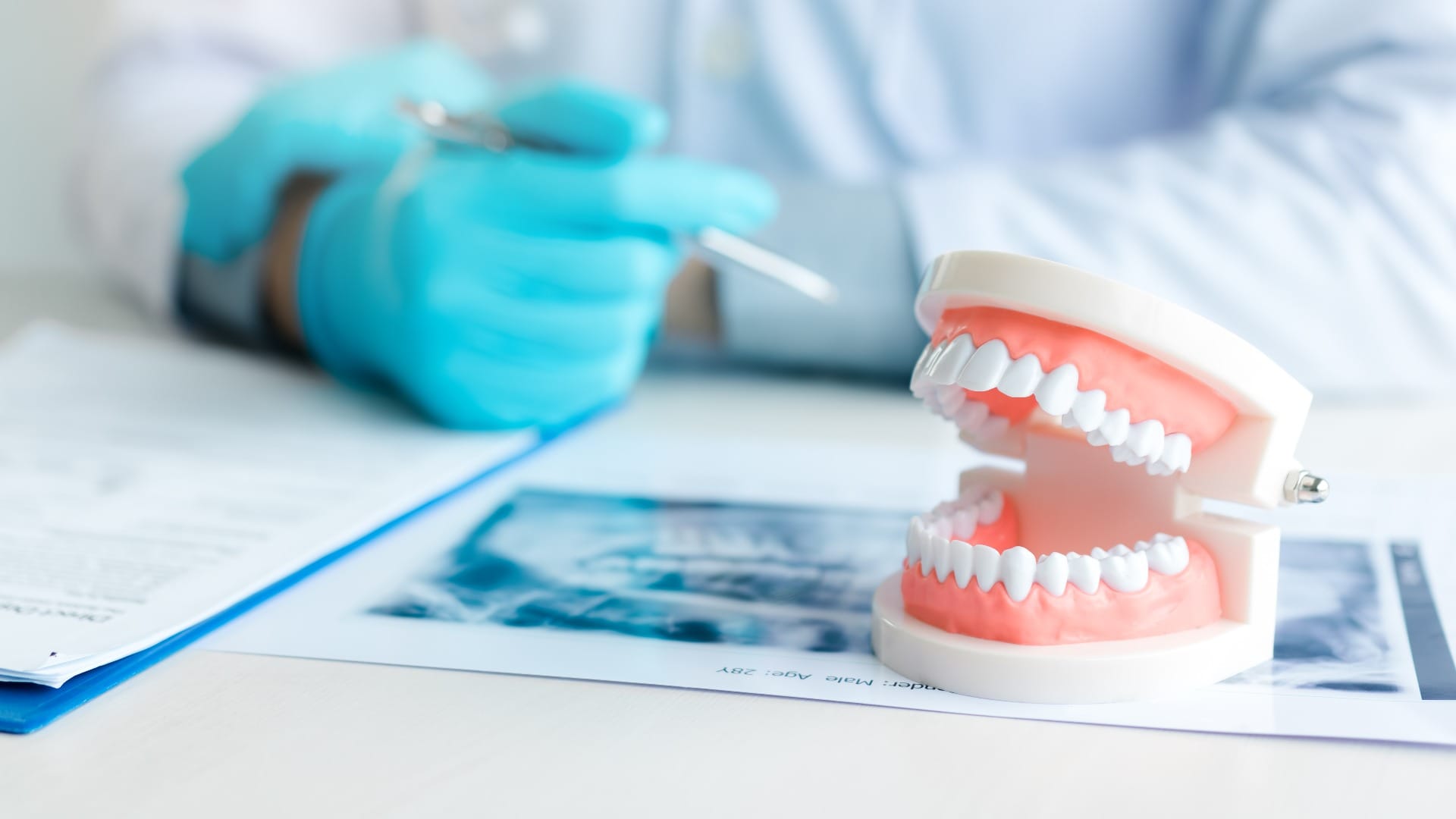 Close up dentures with dentist working on table in clinic.